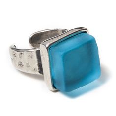 a ring with a square blue stone on it