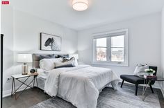 a bedroom with white walls and gray carpet