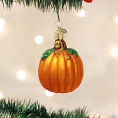 an orange ornament hanging from a christmas tree