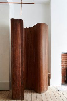 a room divider made out of wood in front of a fireplace