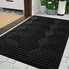 a black door mat in the middle of a room