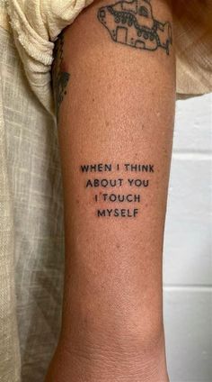 a person with a tattoo on their arm that says, when i think about you it touch my self