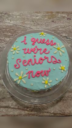 a cake that is sitting on top of a table with words written on the frosting