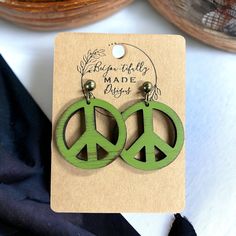 Add a special touch of vintage to your accessories with these peace sign dangle earrings made from reclaimed 100-year-old walnut wooden that has been painted and distressed for a vintage look. Each pair of earrings have been coated with a light oil to give them the perfect finishing touch. These are lightweight for an all-day wear. Earrings are made from Laser engraved and cut wood and hand painted. Earring hardware is made from hypoallergenic stainless steel and come with a silicone back. Your Wood Peace Sign, Wooden Peace Sign, Peace Sign Earrings, Hippie Earrings, Small Gift Boxes, Wooden Earrings, Peace Sign, Vintage Signs, Laser Engraved