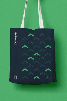 a tote bag hanging on a green wall