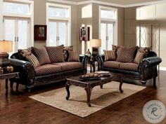 a living room with two couches, a coffee table and lamps on the floor