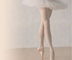 a ballerina in white tutu and ballet shoes