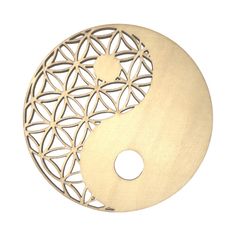 a wooden yin - yang symbol is shown on a white background and has an intricate design in the center