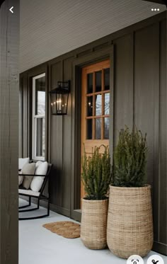 two planters on the front porch of a house