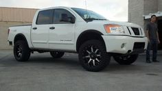 a man standing next to a white truck