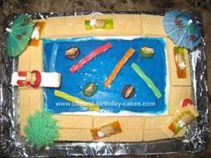 a birthday cake made to look like a beach scene with umbrellas and other items