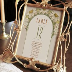 an ornate gold frame holds a table number