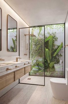 a bathroom with two sinks, a toilet and a large window in the shower area