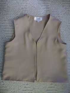 a women's tan vest on the floor