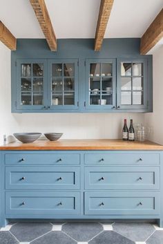 a kitchen with blue cabinets and white walls