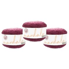 three balls of red yarn with the words nandala on them in gold lettering