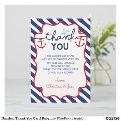 a blue and white striped thank card with an anchor in the center, on top of a table