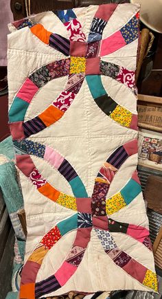 an old quilt is sitting on a chair