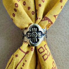 a close up of a tie with a ring on it