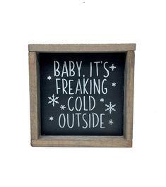 a sign that says baby it's freaking cold outside in white lettering on a black background