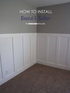 an empty room with white paneling and brown carpet