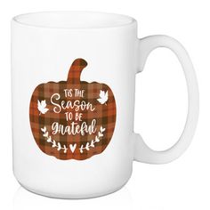 a white coffee mug with the words tis the season to be grateful in plaid pattern