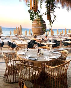 an outdoor dining area with tables and chairs overlooking the ocean