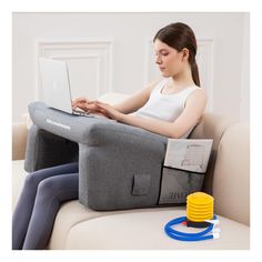 a woman sitting on a couch using a laptop