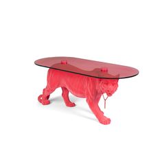 a glass table with a red tiger figurine underneath it