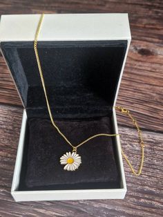 Gold Daisy necklace. All findings and chain used are also gold plated. Only the Daily pendant it gold coloured. Plated Metal Chain Necklace As A Gift, Metal Plated Chain Necklace For Gift, Gold Flower Pendant Choker Necklace, Gold-tone Chain Necklace For Gift, Gold Chain Necklace With Flower Pendant, Gold Plated Chain Necklace Gift, Gold Metal Chain Necklace As Gift, Gold Metal Chain Necklace For Gift, Yellow Gold Plated Chain Necklace Gift