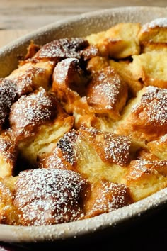 powdered sugar covered pastry in a pan on a table