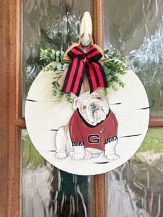 a door hanger with a dog wearing a jersey on it's front porch