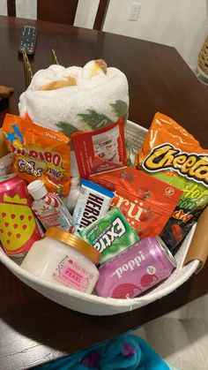 a white bowl filled with candy and snacks