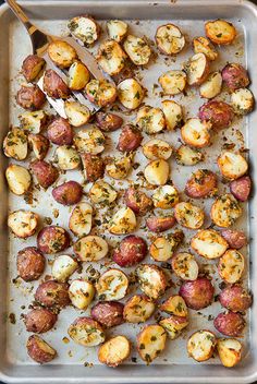 a pan filled with potatoes and meat on top of a table