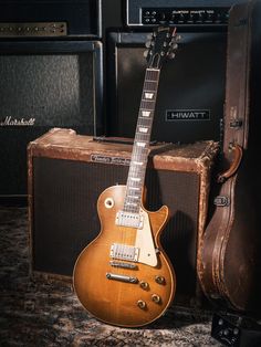 an electric guitar sitting next to some amps