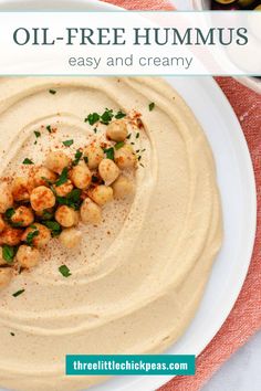 a white plate topped with hummus and garnished with parsley