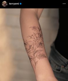 a person with a flower tattoo on their arm