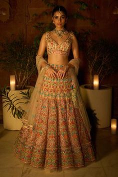 Peach lehenga with attached cancan, embroidered with multicolor sequins, leather patchwork and Swarovski. Comes with embroidered padded blouse and dupatta.
Component: 3
Pattern: Embroidered
Type Of Work: Sequins, Leather Patches and Swarovski Work
Neckline: Plunged V-Neck
Sleeve Type: Sleeveless
Fabric: Soft Net, Lining: Shantoon
Color: Peach
Other Details: 
Multi tassel tie-up lehengas
Sheer embroidered  dupatta
Attached cancan lehengas
Padded blouse
Occasion: Wedding, Bride - Aza Fashions Peach Lehenga, Multicolor Sequins, Desi Wear, Padded Blouse, Bridal Lehengas, Embroidered Dupatta, Leather Patchwork, Indian Fashion Dresses, Floral Bridal