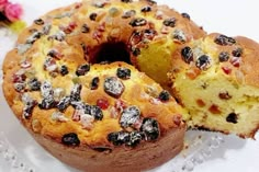 a bundt cake with raisins and cranberries is cut in half