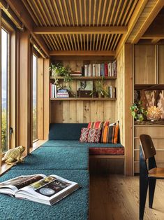 a living room filled with lots of furniture and bookshelves next to a window