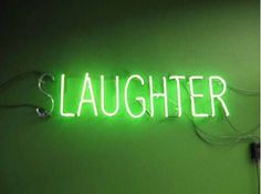 a neon sign that reads slaughterer on the wall