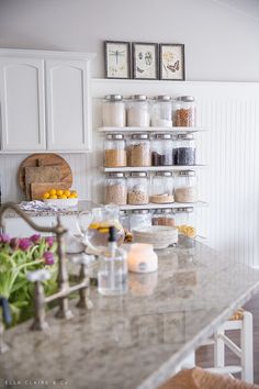 a kitchen counter with jars and spices on it