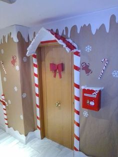 a room decorated for christmas with candy canes and decorations on the door, along with paper snowflakes