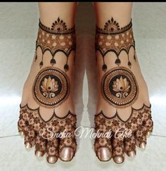 the feet are decorated with henna designs