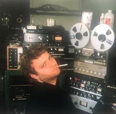 a man is sitting in front of some radio equipment