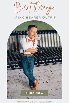 a young boy is standing in front of a bench wearing a bow tie and suspenders