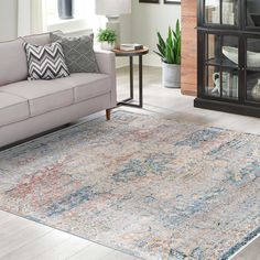 a living room with a couch, chair and rug