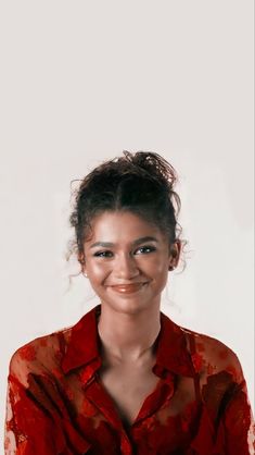 a woman in a red shirt smiling at the camera