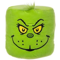 a green pillow with an angry face on it