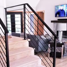 a living room filled with furniture and a flat screen tv on top of a wooden floor